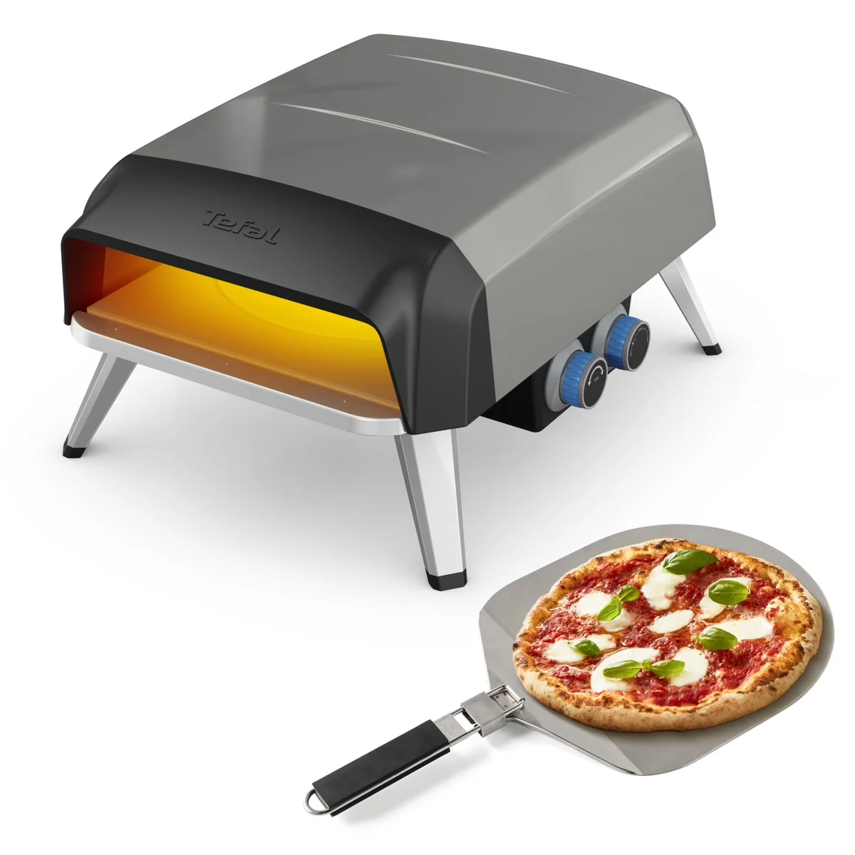 Tefal Pizza Pronto Gaz gris et noir, vue de trois quarts, avec sa pelle à pizza et une margherita